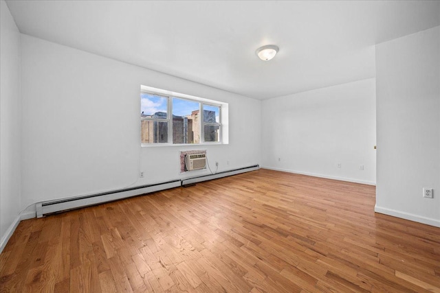 53 Woods Place, New York City, NY 11226 - empty room featuring a baseboard heating unit, wood finished floors, baseboards, and a wall unit AC