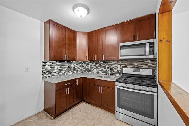 53 Woods Place, New York City, NY 11226 - kitchen featuring appliances with stainless steel finishes, a sink, tasteful backsplash, and light tile patterned flooring