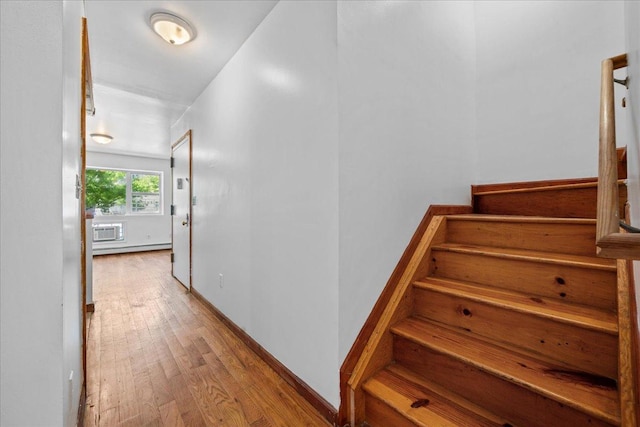 53 Woods Place, New York City, NY 11226 - stairs with wood finished floors, a wall mounted air conditioner, and baseboards