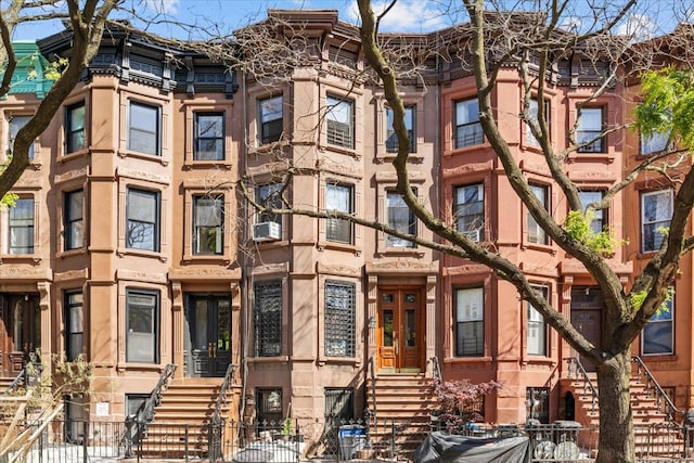 477 Halsey St Unit 4, New York City, NY 11233 - view of property featuring a fenced front yard, cooling unit, and stairs