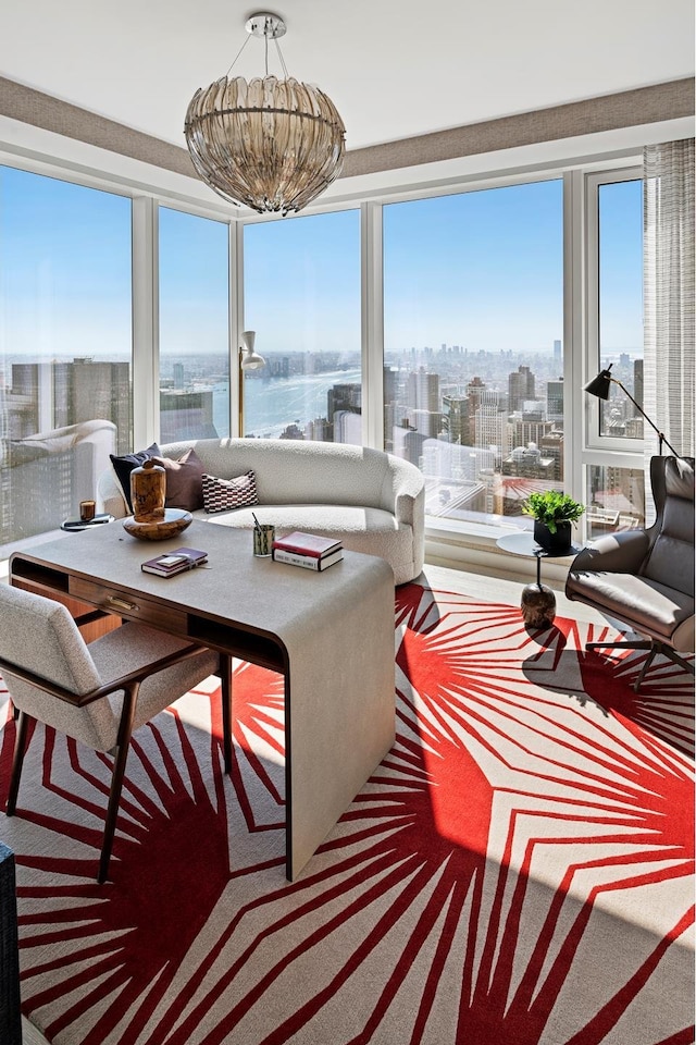 sunroom / solarium featuring a water view and a city view