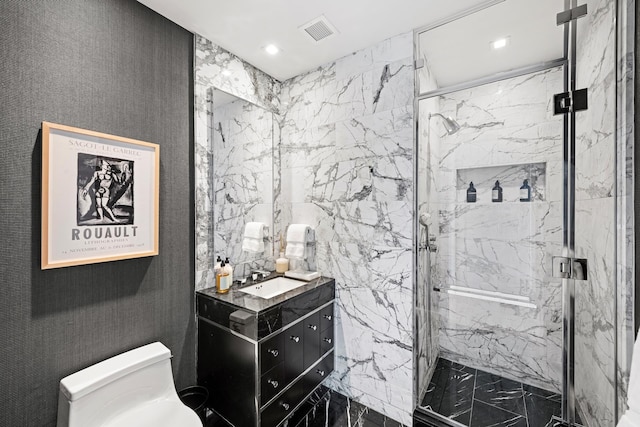 bathroom with toilet, a marble finish shower, vanity, and recessed lighting