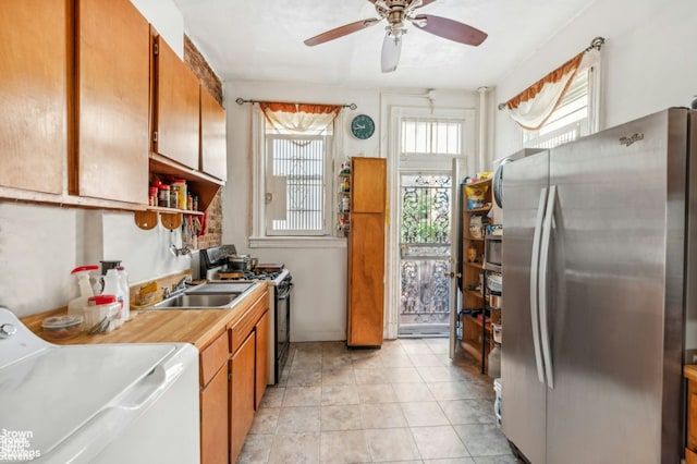 7 Sylvan Ct, New York City, NY 10035 - kitchen featuring freestanding refrigerator, gas range oven, washer and dryer, a ceiling fan, and a sink