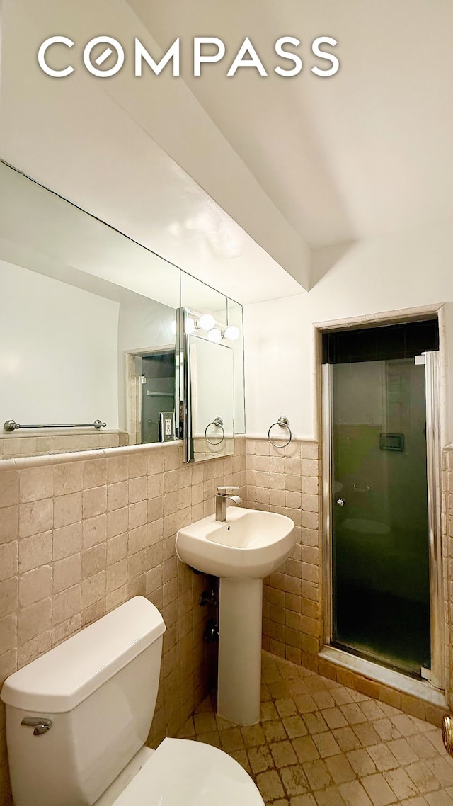 420 E 64th St Unit W4D, New York City, NY 10065 - full bath featuring tile walls, tile patterned floors, a stall shower, and a wainscoted wall
