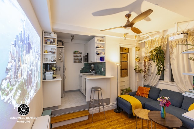 226 E 12th St Unit 1F, New York City, NY 10003 - living area featuring light wood finished floors and a ceiling fan