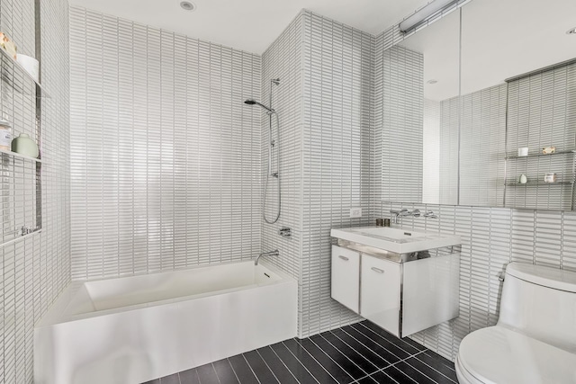 252 S St Unit 47K, New York City, NY 10002 - full bathroom with tile walls, vanity, shower / washtub combination, toilet, and wood finished floors