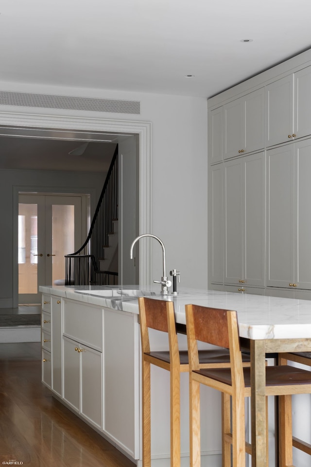 354 W 20th St, New York City, NY 10011 - kitchen featuring dark wood-type flooring, a sink, light countertops, and french doors