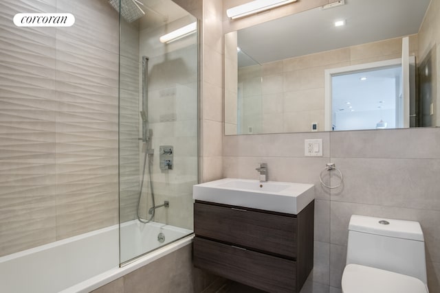 311 Hart St Unit 1A, New York City, NY 11206 - full bath featuring tile walls, tiled shower / bath, and vanity