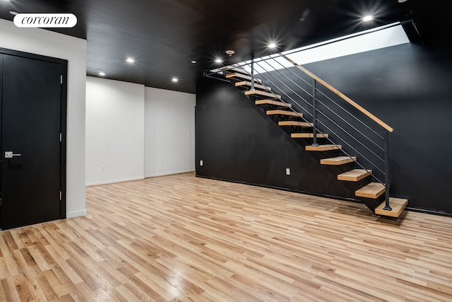 interior space featuring wood finished floors, recessed lighting, and baseboards