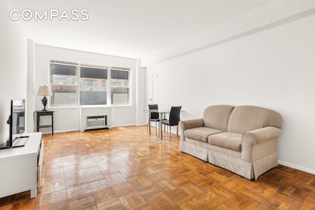 310 E 49th St Unit 7B, New York City, NY 10017 - living area with baseboards and a wall unit AC