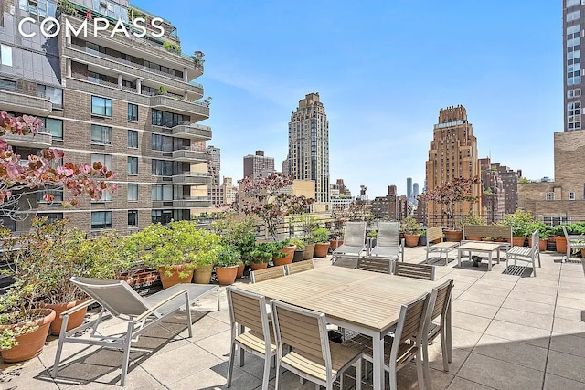 310 E 49th St Unit 7B, New York City, NY 10017 - view of patio / terrace featuring a skyline view and outdoor dining space
