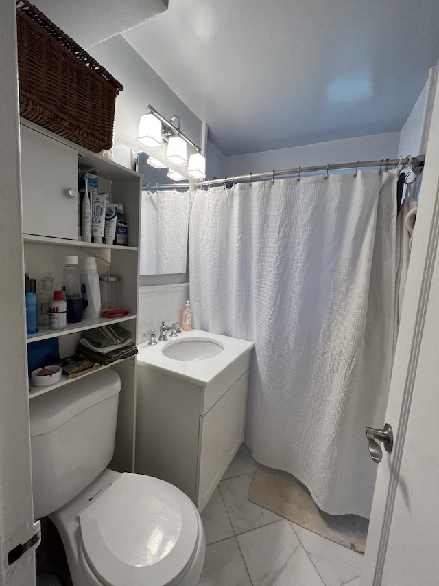 full bath featuring vanity and toilet