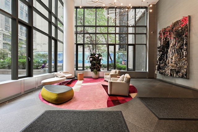 community lobby with a towering ceiling and expansive windows