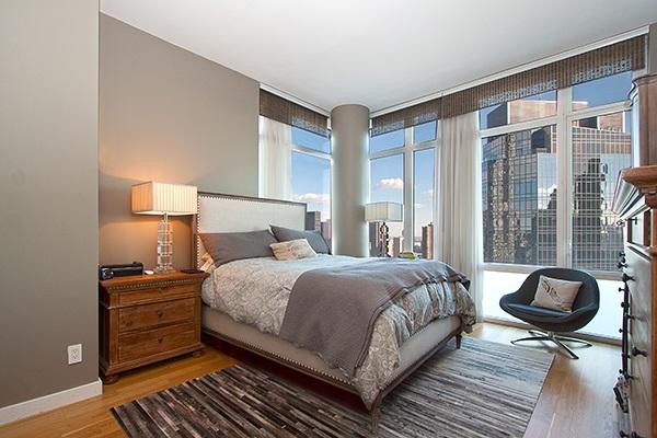 bedroom with light wood finished floors and baseboards