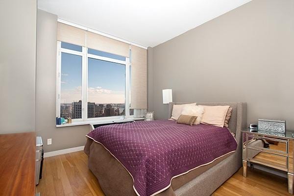 bedroom with wood finished floors and baseboards