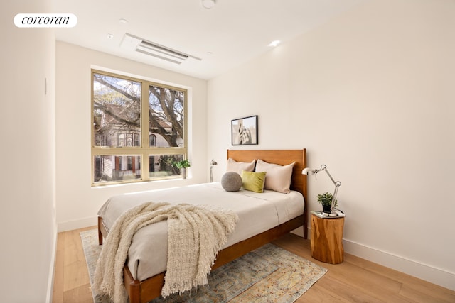 bedroom featuring wood finished floors and baseboards