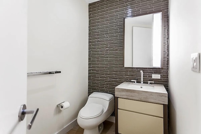 75 Wall St Unit 18Fg, New York City, NY 10005 - half bathroom featuring tile walls, toilet, vanity, and tasteful backsplash