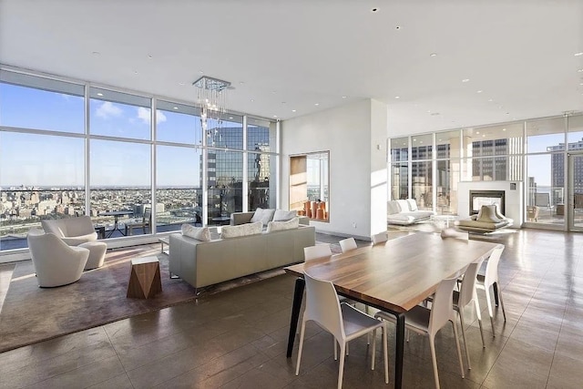 75 Wall St Unit 18Fg, New York City, NY 10005 - dining space featuring a wall of windows and a fireplace