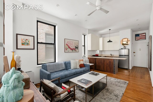 360 W 21st St Unit 2L, New York City, NY 10011 - living room with light wood finished floors and ceiling fan