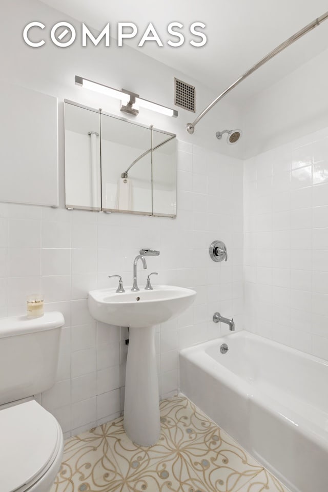 360 W 21st St Unit 2L, New York City, NY 10011 - full bath featuring shower / bath combination, tile patterned floors, and tile walls