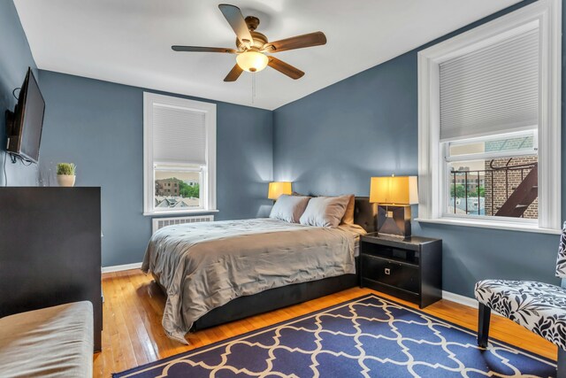 88-01 35th Ave Unit 5F, New York City, NY 11372 - bedroom featuring wood finished floors, baseboards, a ceiling fan, and vaulted ceiling