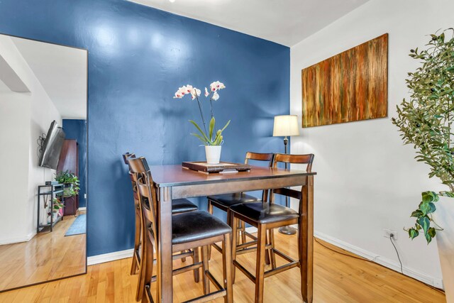 88-01 35th Ave Unit 5F, New York City, NY 11372 - dining room featuring wood finished floors and baseboards