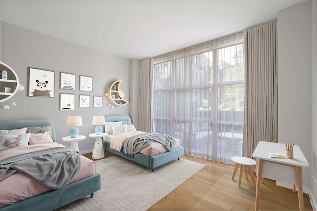 bedroom with wood finished floors and baseboards