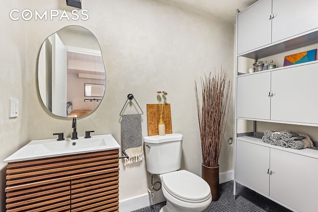 495 Rutland Rd Unit 1, New York City, NY 11203 - bathroom with vanity, toilet, baseboards, and tile patterned flooring