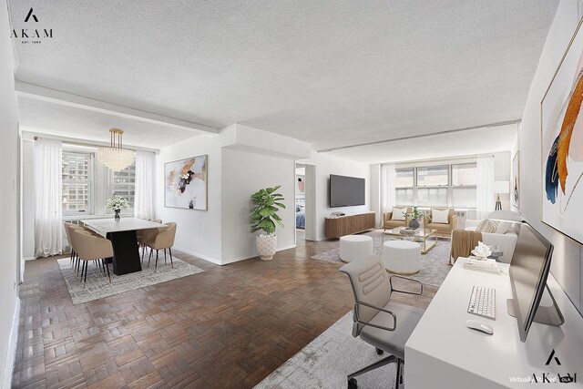 living room featuring a textured ceiling and baseboards