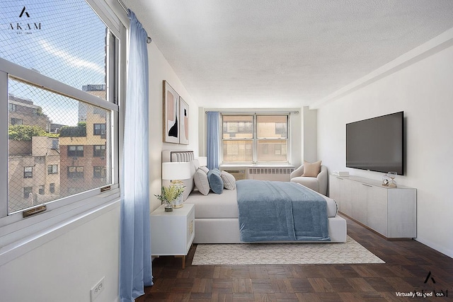 bedroom featuring a textured ceiling and baseboards