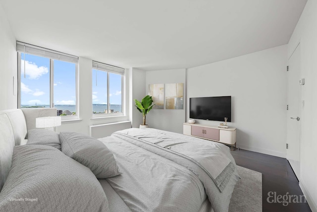bedroom featuring dark wood-style flooring and baseboards