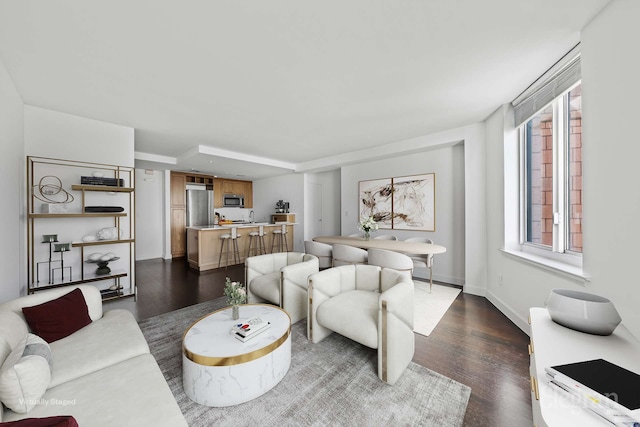 living area featuring dark wood-style floors and baseboards