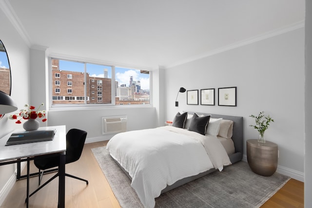 625 Main St Unit 834, New York City, NY 10044 - bedroom with ornamental molding, wood finished floors, baseboards, a wall mounted AC, and a view of city