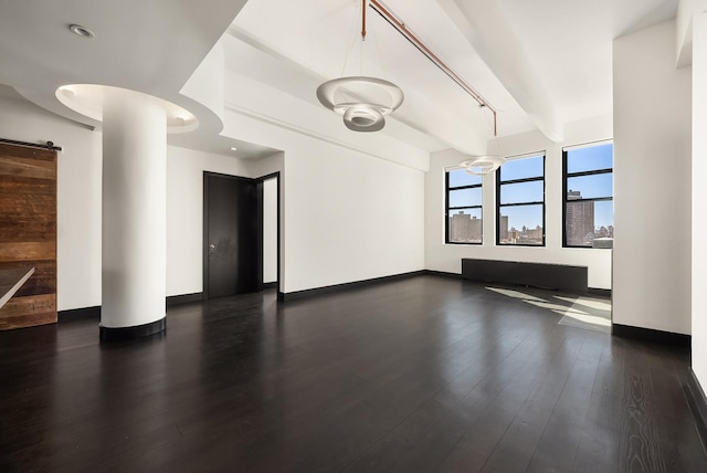 60 Broadway Unit 7K, New York City, NY 11249 - unfurnished living room with baseboards, dark wood finished floors, and beamed ceiling