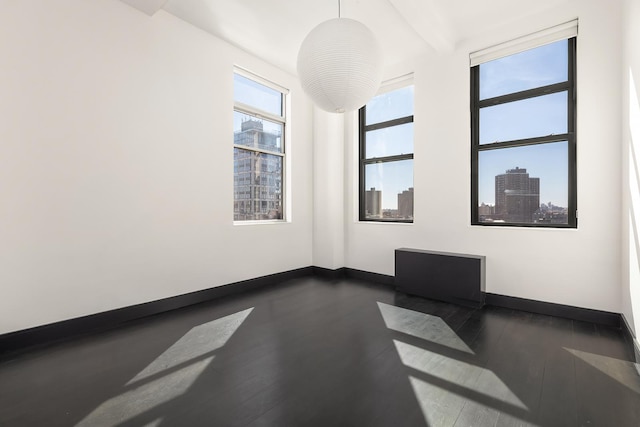60 Broadway Unit 7K, New York City, NY 11249 - unfurnished room featuring baseboards and dark wood-type flooring
