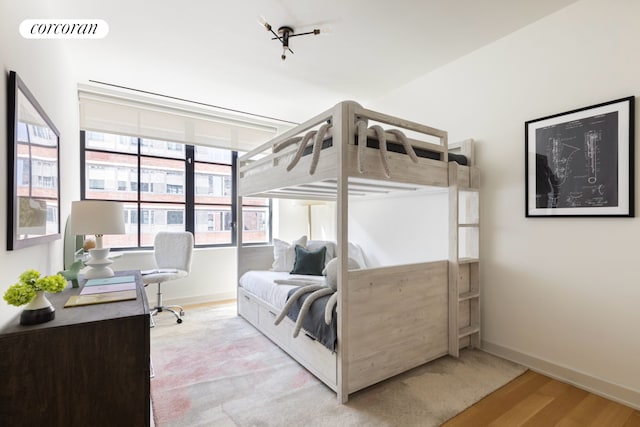 550 W 29th St Unit 9Afl, New York City, NY 10001 - bedroom featuring baseboards and wood finished floors