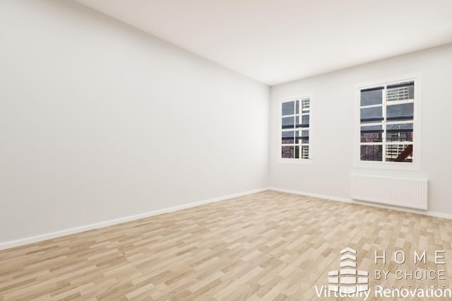 415 E 80th St Unit 3E, New York City, NY 10075 - empty room with radiator, light wood-style flooring, and baseboards