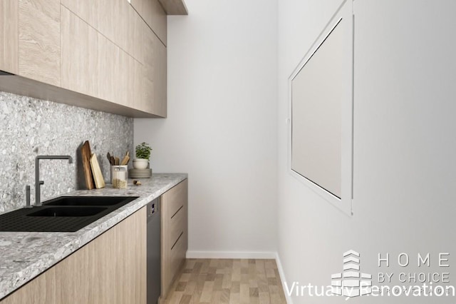 415 E 80th St Unit 3E, New York City, NY 10075 - kitchen with light brown cabinets, modern cabinets, decorative backsplash, light wood-style flooring, and a sink