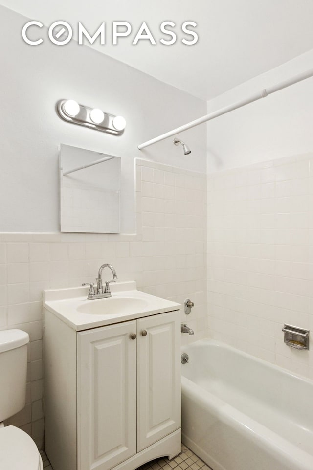 333 E 79th St Unit 9Y, New York City, NY 10075 - full bath with toilet, bathtub / shower combination, tile walls, vanity, and tile patterned flooring