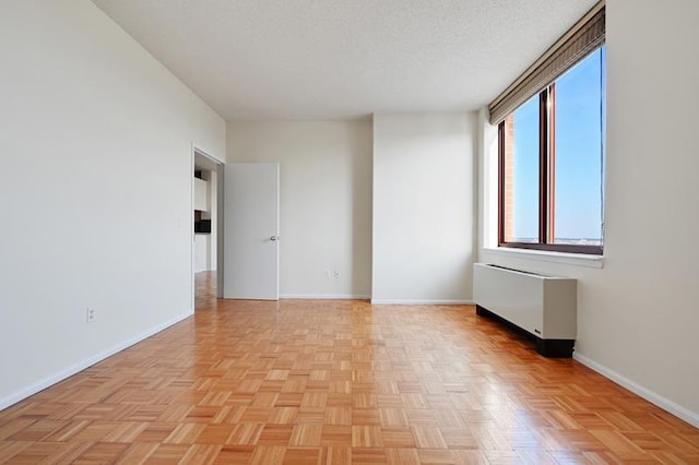 4-74 48th Ave Unit 38-H, New York City, NY 11109 - unfurnished room with radiator and baseboards