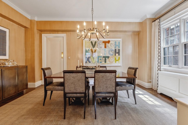 1035 Park Ave Unit 6B, New York City, NY 10028 - dining space featuring a chandelier, ornamental molding, wood finished floors, and baseboards