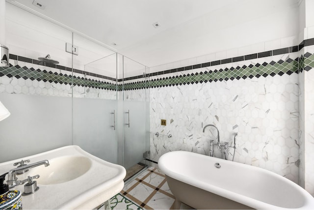 390 W End Ave Unit 2H, New York City, NY 10024 - bathroom featuring inlaid floor details, a freestanding bath, a stall shower, and a sink