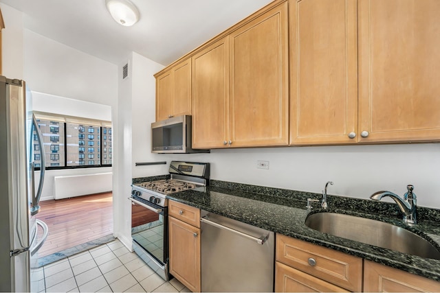 343 E 74th St Unit Ph2A, New York City, NY 10021 - kitchen featuring appliances with stainless steel finishes, light tile patterned floors, and dark stone countertops