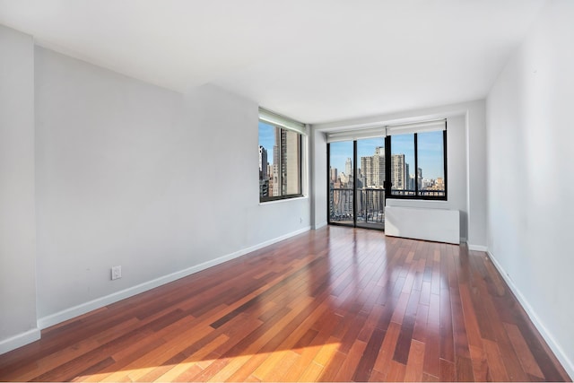 343 E 74th St Unit Ph2A, New York City, NY 10021 - unfurnished room featuring hardwood / wood-style floors and baseboards