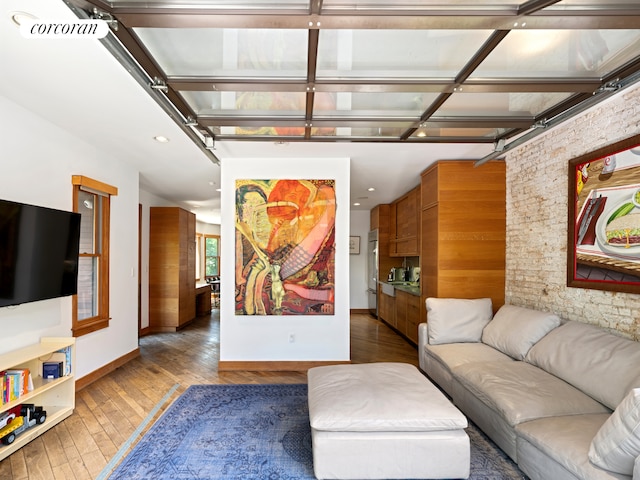 living room featuring hardwood / wood-style floors and baseboards