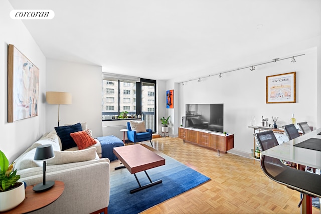 250 E 40th St Unit 17F, New York City, NY 10016 - living room featuring rail lighting and baseboards