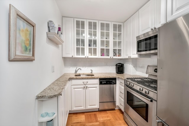 230 E 15th St Unit 2C, New York City, NY 10003 - kitchen featuring stainless steel appliances, a sink, and white cabinetry
