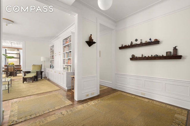 200 W 54th St Unit 8G, New York City, NY 10019 - hallway with wood finished floors, ornamental molding, wainscoting, and a decorative wall