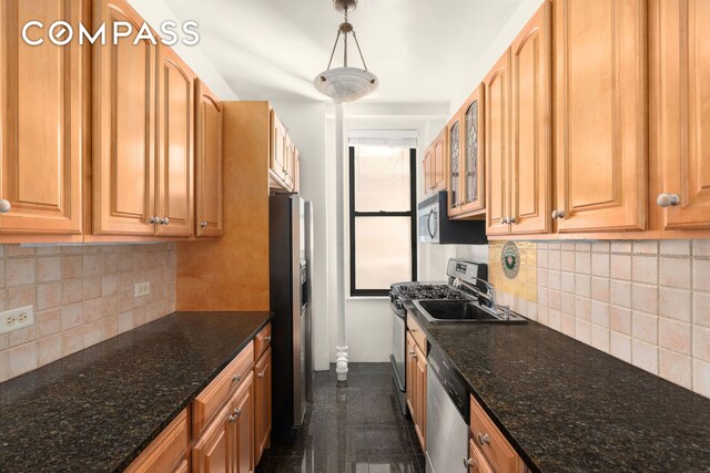 200 W 54th St Unit 8G, New York City, NY 10019 - kitchen featuring stainless steel appliances, decorative backsplash, glass insert cabinets, and dark stone countertops