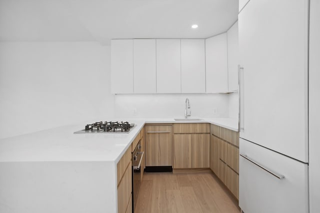 1330 5th Ave Unit 4M, New York City, NY 10026 - kitchen with a sink, stainless steel gas cooktop, light countertops, modern cabinets, and light wood-type flooring